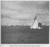 SACRED TIPI WITH GREEN BRANCHES OUTSIDE.